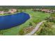 Stunning aerial view of lush golf course community with a scenic lake, surrounded by beautiful homes at 1241 Creek Nine Dr, North Port, FL 34291