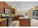 Open kitchen with stainless appliances, granite countertops overlooks the lanai at 1241 Creek Nine Dr, North Port, FL 34291