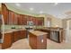 Kitchen has stainless appliances, granite countertops and a center island at 1241 Creek Nine Dr, North Port, FL 34291