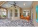Inviting outdoor patio features a ceiling fan, pavers, and plenty of natural light at 1241 Creek Nine Dr, North Port, FL 34291