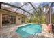 Inviting screened-in pool area with tile surround and access to the home's interior via sliding glass doors at 1241 Creek Nine Dr, North Port, FL 34291