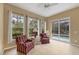 Sitting area features tile floor, large windows and access to the pool at 1241 Creek Nine Dr, North Port, FL 34291
