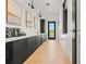 Stylish corridor features elegant black cabinets, and contemporary artwork enhancing the space's aesthetic appeal at 12418 Asana Ct, Venice, FL 34293