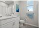 Bathroom featuring modern fixtures, single marble vanity, toilet, and window at 12418 Asana Ct, Venice, FL 34293