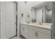 Bathroom with double vanity sinks, marble countertops, and a view of the glass shower at 12418 Asana Ct, Venice, FL 34293