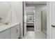 Bathroom view to a bedroom featuring a shower and single marble vanity sink at 12418 Asana Ct, Venice, FL 34293