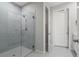 Modern bathroom featuring a glass-enclosed shower with tile surround and sleek fixtures at 12418 Asana Ct, Venice, FL 34293