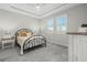 Cozy bedroom with a queen-size bed, two windows, and light gray carpet at 12418 Asana Ct, Venice, FL 34293