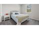 A cozy bedroom with a black metal bed frame and carpeted floors offers a serene retreat at 12418 Asana Ct, Venice, FL 34293