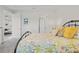 Bright bedroom with a floral quilt and black metal bed frame offers a comfortable space at 12418 Asana Ct, Venice, FL 34293