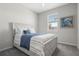 Bedroom with a rustic wooden bed frame and a light fixture provides a relaxing retreat at 12418 Asana Ct, Venice, FL 34293