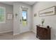 Inviting foyer features natural light, neutral walls, and classic furnishings at 12418 Asana Ct, Venice, FL 34293