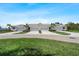 Charming villas featuring well-manicured lawns, attached garages, and inviting landscaping at 12418 Asana Ct, Venice, FL 34293