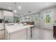 Modern kitchen island with seating, open to the living room and dining area at 12418 Asana Ct, Venice, FL 34293