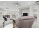 Open-concept living area with a comfortable recliner, sectional sofa, dining area, and kitchen island at 12418 Asana Ct, Venice, FL 34293