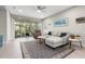 Bright living room featuring a comfortable couch and a screened patio with outdoor seating at 12418 Asana Ct, Venice, FL 34293