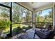 Cozy screened lanai with comfortable seating and lush views of nature at 12418 Asana Ct, Venice, FL 34293
