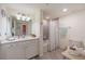 Bright bathroom featuring tiled floors, a single sink vanity, and shower with tub at 12500 Ghiberti Cir # 101, Venice, FL 34293