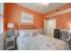 Bright bedroom featuring a decorative metal headboard, and an adjacent home office area at 12500 Ghiberti Cir # 101, Venice, FL 34293