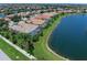 Stunning aerial view of property featuring a private pool, and lakefront views at 13150 Huerta St, Venice, FL 34293