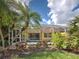 Lush landscaping with a screened-in pool and cozy seating on a beautiful sunny day at 13150 Huerta St, Venice, FL 34293