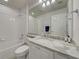 Well-lit bathroom featuring granite countertops, offering a luxurious and functional space at 13150 Huerta St, Venice, FL 34293