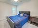 Bedroom with dark wood bed frame, shuttered window and carpeting at 13150 Huerta St, Venice, FL 34293
