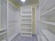 Walk-in closet with white shelving and hanging racks at 13150 Huerta St, Venice, FL 34293