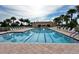 Enjoy the large community pool surrounded by lounge chairs and palm trees at 13150 Huerta St, Venice, FL 34293