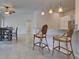 Open-concept dining area features tile floors, modern lighting, and bar seating at 13150 Huerta St, Venice, FL 34293