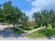 Beautiful home exterior featuring mature trees, lush landscaping, and a welcoming curb appeal at 13150 Huerta St, Venice, FL 34293