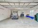 Spacious garage interior featuring a golf cart, ample storage space, and a well-lit environment at 13150 Huerta St, Venice, FL 34293