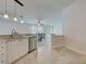 Open-concept kitchen featuring stone countertops, tile flooring, and stainless steel appliances at 13150 Huerta St, Venice, FL 34293