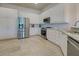 Bright kitchen features white cabinets, stainless steel appliances, and granite countertops at 13150 Huerta St, Venice, FL 34293