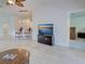 Open-concept living room featuring tile flooring, modern lighting, and an entertainment center with a flat-screen TV at 13150 Huerta St, Venice, FL 34293