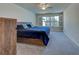 This main bedroom features cool tones, new carpet, and a ceiling fan at 13150 Huerta St, Venice, FL 34293