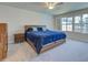 Spacious main bedroom with a large window, ceiling fan, and plush carpeting at 13150 Huerta St, Venice, FL 34293