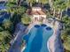 Stunning aerial view of a large pool surrounded by palm trees, perfect for relaxation and entertainment at 13150 Huerta St, Venice, FL 34293