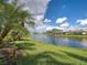 Scenic water view showcasing the tranquil lake and lush landscaping, perfect for peaceful living at 13150 Huerta St, Venice, FL 34293