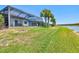 Large, screened lanai and spacious backyard with lush green lawn and a tranquil view of the community lake at 13511 Esposito St, Venice, FL 34293