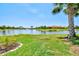 Beautiful backyard overlooking a serene lake with a bridge and lush greenery, perfect for relaxation and outdoor enjoyment at 13511 Esposito St, Venice, FL 34293