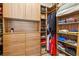 Custom closet offers ample storage with built-in shelving, drawers, and hanging rods for organization at 13511 Esposito St, Venice, FL 34293