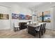 Bright dining room featuring stylish wood table, modern lighting, and picturesque waterfront view at 13511 Esposito St, Venice, FL 34293