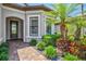 Inviting front entrance featuring a brick paver walkway and beautiful landscaping at 13511 Esposito St, Venice, FL 34293