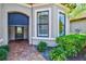 Inviting front entrance featuring a brick paver walkway and beautiful landscaping at 13511 Esposito St, Venice, FL 34293
