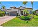 Charming exterior view of house with attractive landscaping and a brick paver driveway at 13511 Esposito St, Venice, FL 34293