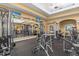 Well-equipped gym features modern weight machines, dumbbells, and a mirrored wall at 13511 Esposito St, Venice, FL 34293