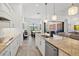 Spacious kitchen with island seating, stainless steel appliances, and an open layout to the living area at 13511 Esposito St, Venice, FL 34293