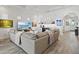 Inviting living room features comfortable seating, a large TV, and a built-in bar area at 13511 Esposito St, Venice, FL 34293