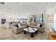 Spacious living area with comfortable seating, open to kitchen and outdoor view of the lake at 13511 Esposito St, Venice, FL 34293